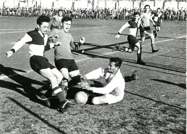 אשר זליקוביץ' מול שוער הפועל חיפה, משה פלדשטיין. בועז קופמן תומך לצידו. התמונה ממשחק ידידות מול הפועל חיפה (0:5) שנערך ב-25/1/1955.