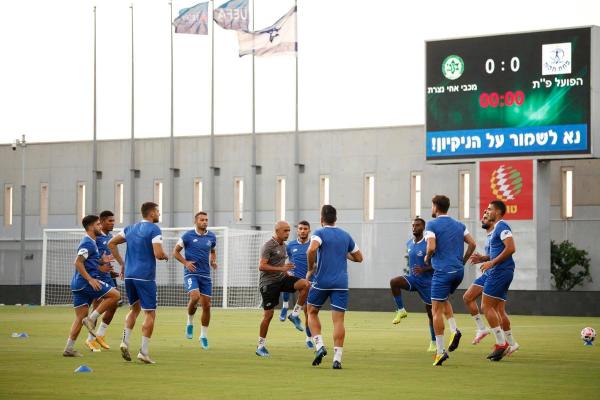 שחקני הפועל פ"ת מתחממים לקראת המשחק